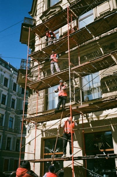 Compagnons au travail sur un échafaudage de façade